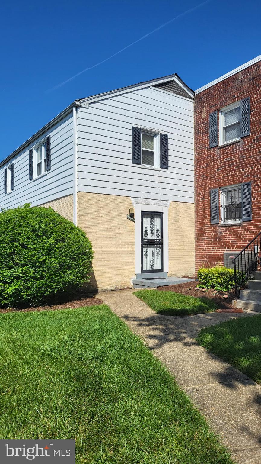 2510 Iverson St Unit 2510, Temple Hills, MD 20748 - view of front facade with brick siding and a front lawn