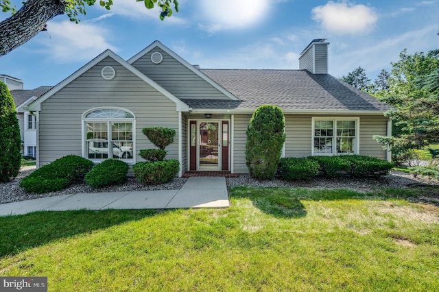 3217 Garfield Ave, Reading, PA 19605 - view of front of home with a front yard, a chimney, and a shingled roof