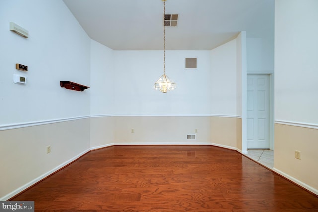 3217 Garfield Ave, Reading, PA 19605 - unfurnished room featuring wood finished floors and a chandelier