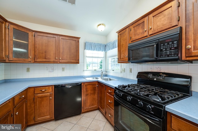 3217 Garfield Ave, Reading, PA 19605 - kitchen featuring black appliances, brown cabinetry, and tasteful backsplash