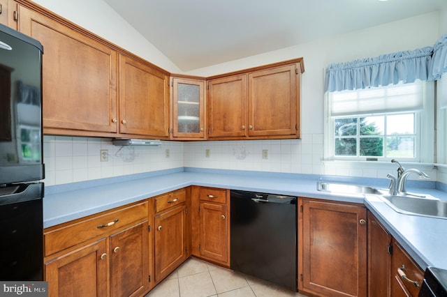 3217 Garfield Ave, Reading, PA 19605 - kitchen with black appliances, vaulted ceiling, light countertops, backsplash, and brown cabinetry