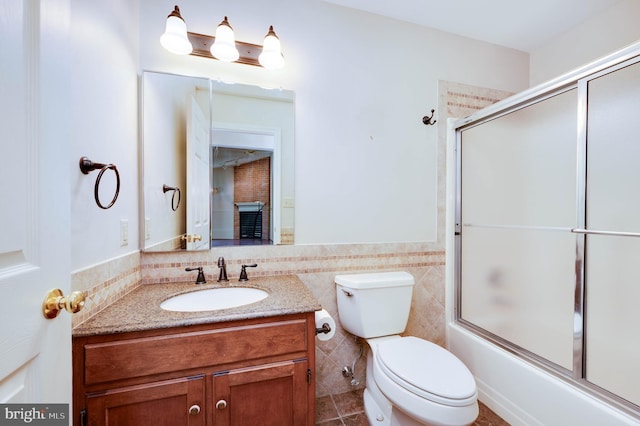 3217 Garfield Ave, Reading, PA 19605 - full bathroom with vanity, enclosed tub / shower combo, tile patterned floors, tile walls, and wainscoting