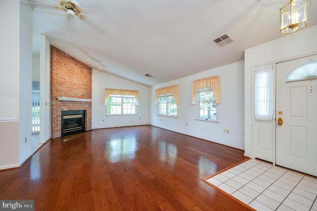 3217 Garfield Ave, Reading, PA 19605 - foyer with wood finished floors, vaulted ceiling, ceiling fan, and a fireplace
