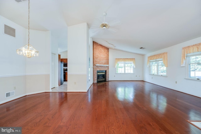 3217 Garfield Ave, Reading, PA 19605 - unfurnished living room featuring vaulted ceiling, wood finished floors, plenty of natural light, and a chandelier