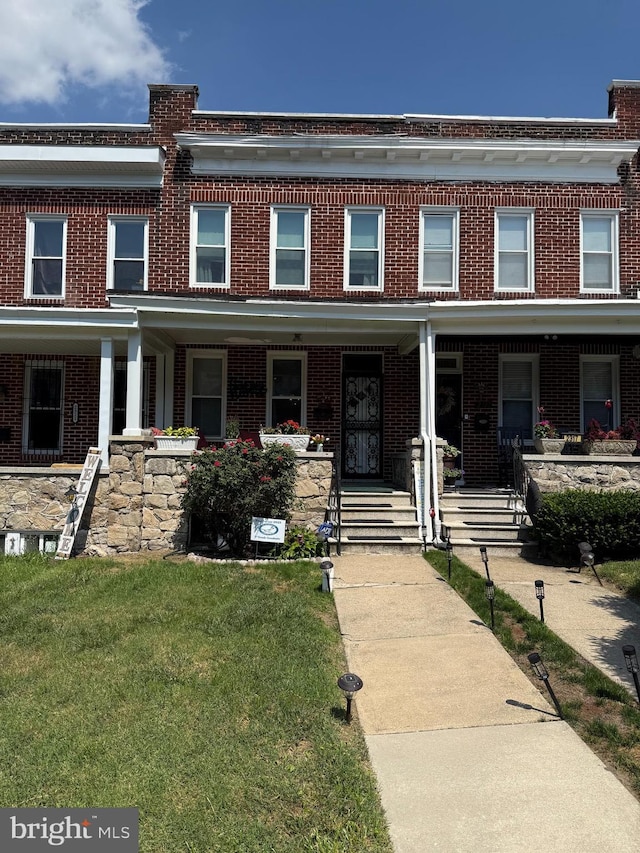 2319 N Rosedale St, Baltimore, MD 21216 - multi unit property featuring brick siding, a porch, and a front yard