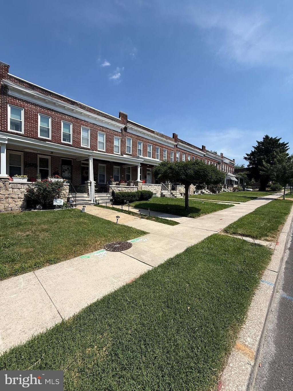 2319 N Rosedale St, Baltimore, MD 21216 - view of front facade featuring covered porch and a front yard