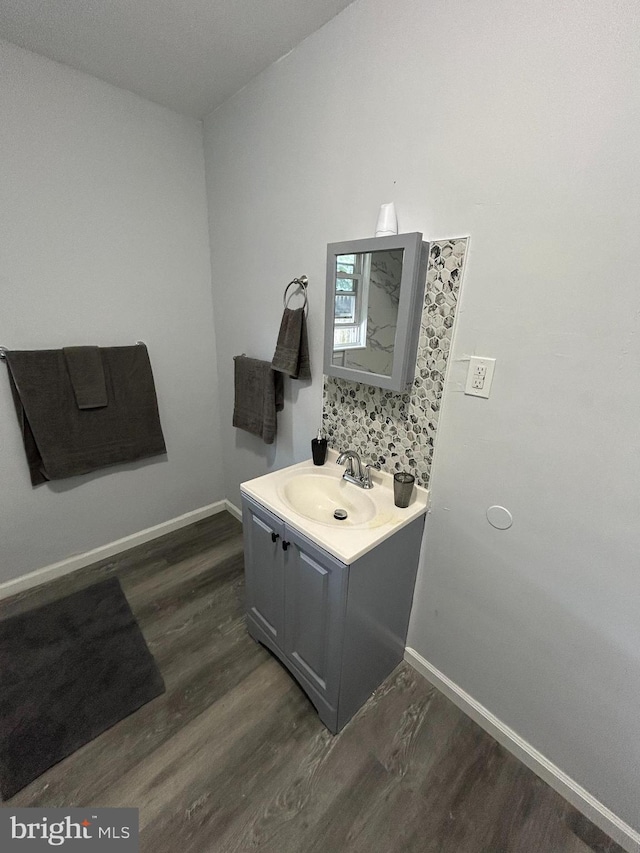 217 Washington St, Trenton, NJ 08611 - bathroom with wood finished floors, vanity, and decorative backsplash