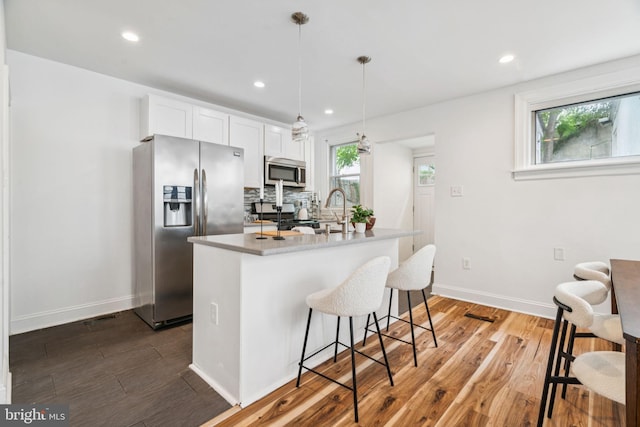 3827 Marshall Rd, Drexel Hill, PA 19026 - kitchen with stainless steel appliances, wood finished floors, a breakfast bar, recessed lighting, and white cabinetry