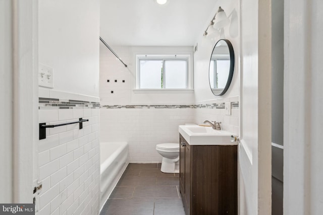 3827 Marshall Rd, Drexel Hill, PA 19026 - full bathroom with tile walls, tile patterned floors, vanity, washtub / shower combination, and a wainscoted wall