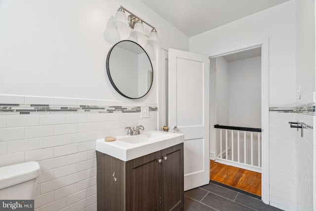 3827 Marshall Rd, Drexel Hill, PA 19026 - bathroom featuring tile walls, vanity, and wainscoting