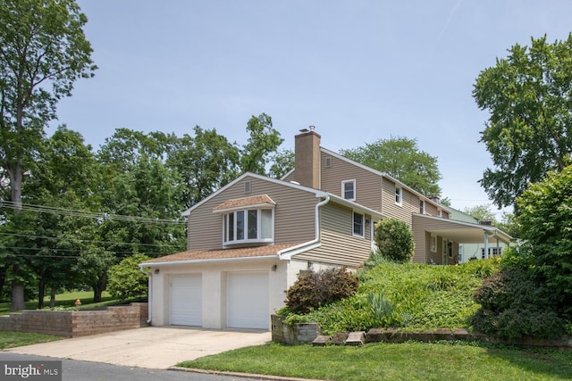56 Meadowbrook Ave, Hatboro, PA 19040 - view of front of house featuring a chimney, an attached garage, concrete driveway, and stucco siding