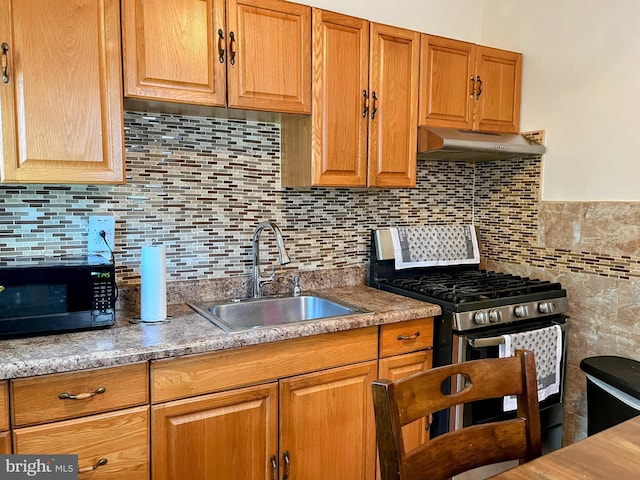 5905 N 3rd St, Philadelphia, PA 19120 - kitchen with stainless steel range with gas cooktop, exhaust hood, black microwave, and backsplash