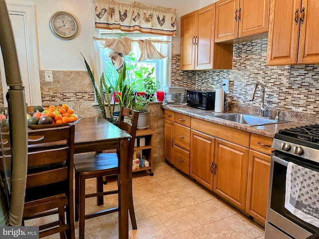 5905 N 3rd St, Philadelphia, PA 19120 - kitchen featuring stainless steel range with gas stovetop, decorative backsplash, and brown cabinetry