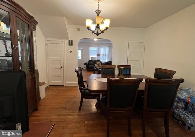 5905 N 3rd St, Philadelphia, PA 19120 - dining room featuring arched walkways, a chandelier, and dark wood-style floors