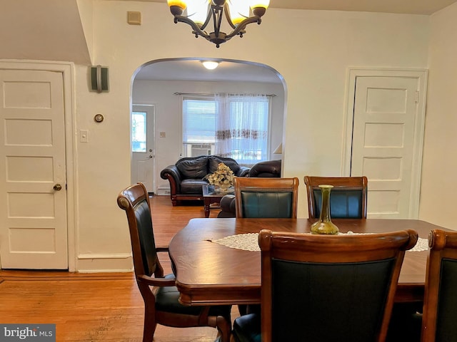 5905 N 3rd St, Philadelphia, PA 19120 - dining area with arched walkways, a chandelier, and wood finished floors