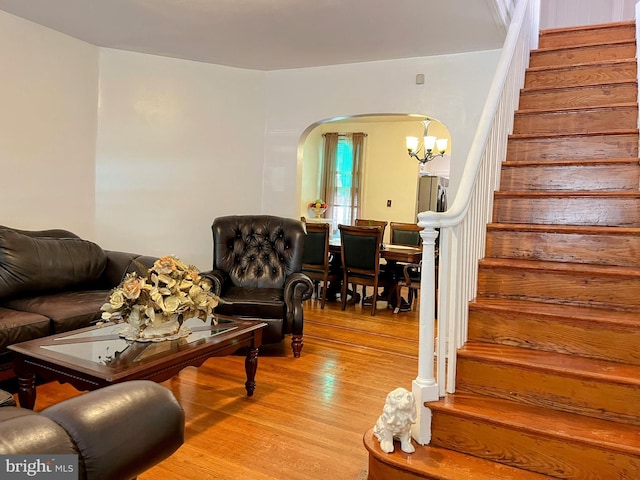 5905 N 3rd St, Philadelphia, PA 19120 - living room with arched walkways, stairs, wood finished floors, and a chandelier