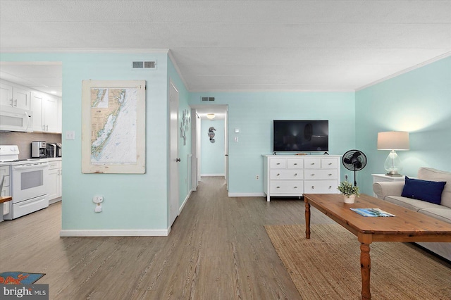 9 76th St Unit 203, Ocean City, MD 21842 - living room with ornamental molding and light wood-style floors
