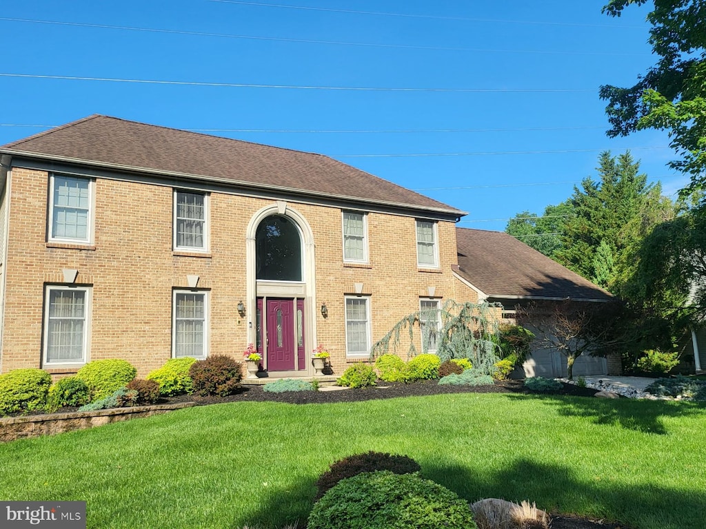 13 Periwinkle Dr, Mount Laurel, NJ 08054 - colonial-style house featuring a front lawn, brick siding, and roof with shingles