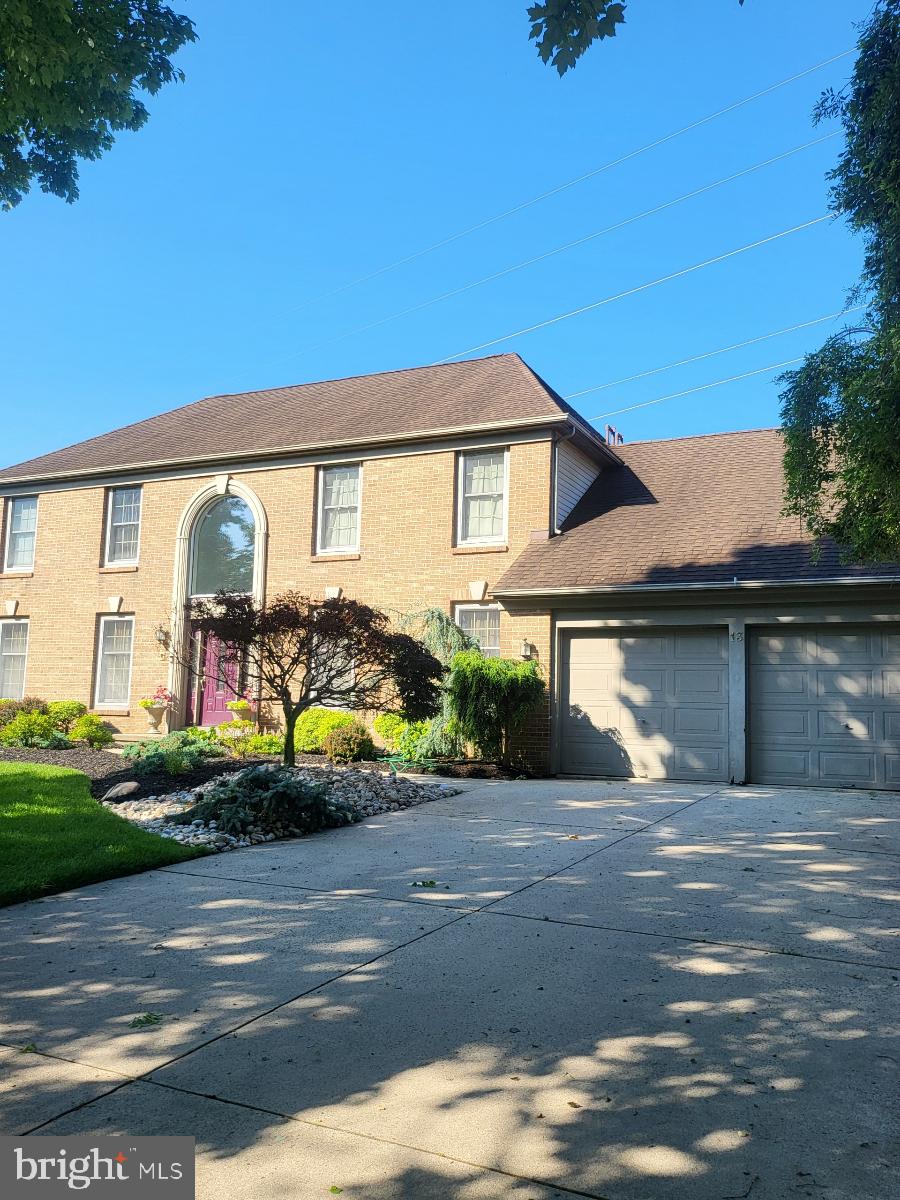 13 Periwinkle Dr, Mount Laurel, NJ 08054 - view of front of house featuring a garage, brick siding, and driveway