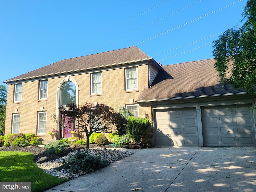 13 Periwinkle Dr, Mount Laurel, NJ 08054 - colonial inspired home featuring concrete driveway, brick siding, a garage, and a shingled roof