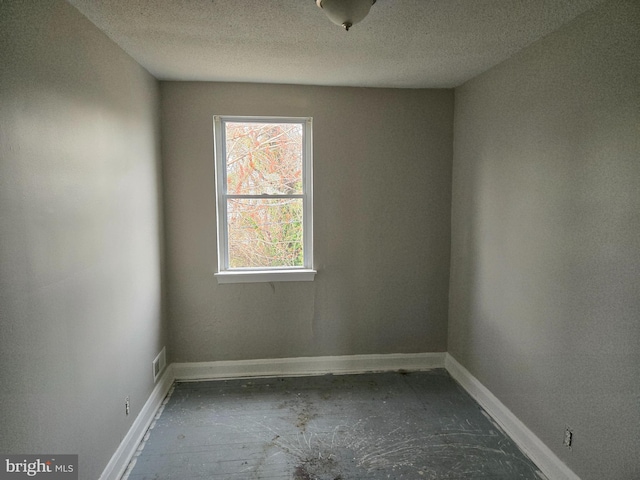 2660 Park Heights Ter, Baltimore, MD 21215 - unfurnished room featuring a textured ceiling and baseboards