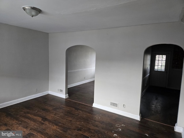 2660 Park Heights Ter, Baltimore, MD 21215 - empty room with arched walkways and wood-type flooring