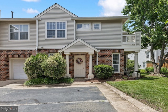 45050 Brae Ter Unit 101, Ashburn, VA 20147 - view of property featuring brick siding, a front lawn, and an attached garage