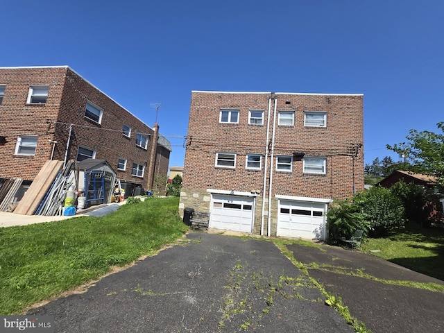 8305 Ridgeway St, Philadelphia, PA 19111 - rear view of house with a garage, driveway, and brick siding