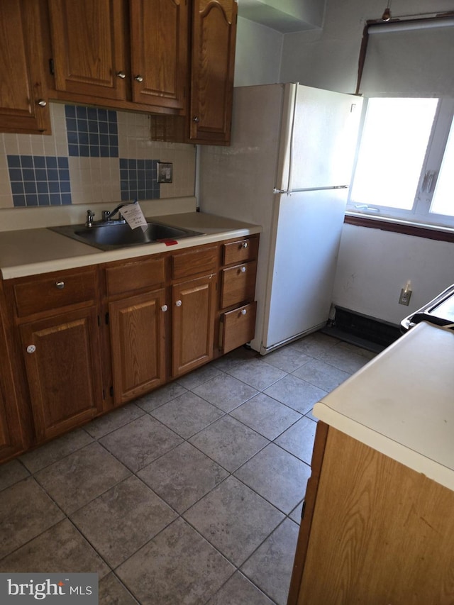8305 Ridgeway St, Philadelphia, PA 19111 - kitchen with decorative backsplash, light countertops, light tile patterned flooring, and brown cabinetry
