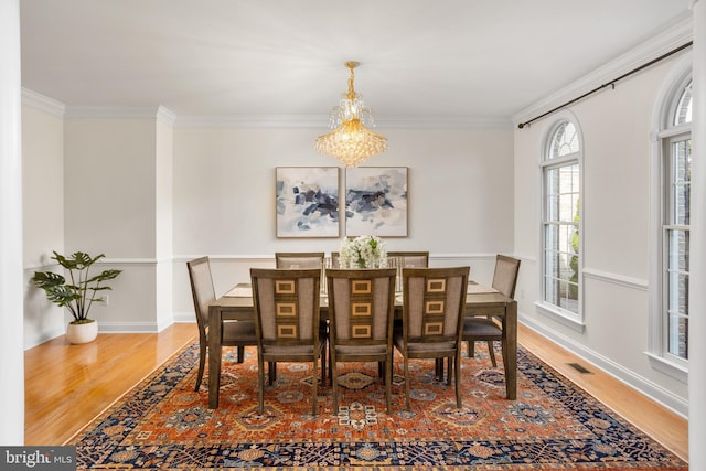7 Shady Brook Ln, Cranbury, NJ 08512 - dining space featuring wood finished floors, crown molding, and a chandelier