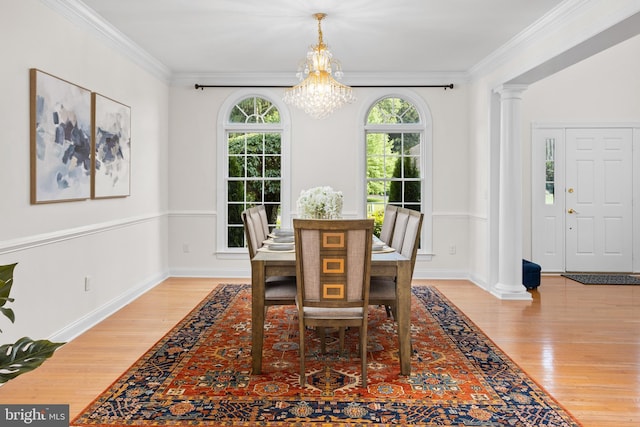 7 Shady Brook Ln, Cranbury, NJ 08512 - dining room featuring ornate columns, light wood finished floors, a chandelier, and crown molding