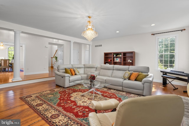 7 Shady Brook Ln, Cranbury, NJ 08512 - living area with ornate columns, a chandelier, wood finished floors, stairs, and recessed lighting