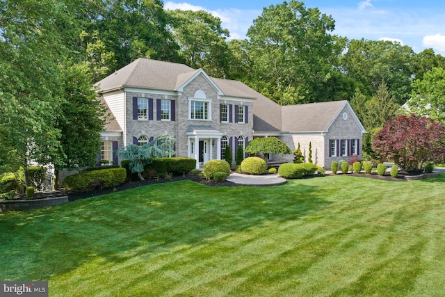 7 Shady Brook Ln, Cranbury, NJ 08512 - colonial inspired home featuring a front yard, stone siding, and brick siding
