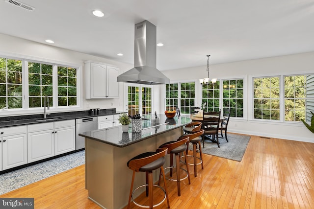 7 Shady Brook Ln, Cranbury, NJ 08512 - kitchen with island exhaust hood, stainless steel dishwasher, light wood-style floors, a breakfast bar, and white cabinets