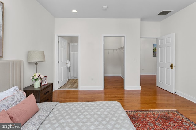 7 Shady Brook Ln, Cranbury, NJ 08512 - bedroom with wood finished floors, a walk in closet, recessed lighting, and a closet