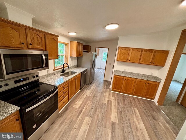 269 Grand View Dr, Keyser, WV 26726 - kitchen with stainless steel appliances, brown cabinets, light wood-style flooring, healthy amount of natural light, and lofted ceiling