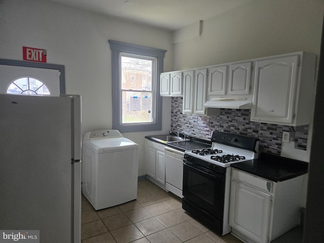 1806 N Bentalou St, Baltimore, MD 21216 - kitchen featuring washer / dryer, white appliances, under cabinet range hood, decorative backsplash, and dark countertops