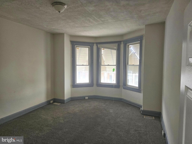 1806 N Bentalou St, Baltimore, MD 21216 - spare room featuring dark colored carpet and a textured ceiling