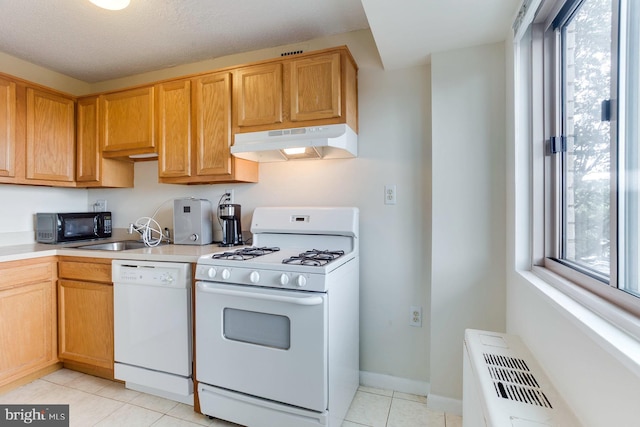 2500 N Van Dorn St Unit 415, Alexandria, VA 22302 - kitchen with white appliances, under cabinet range hood, light tile patterned floors, and light countertops
