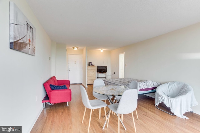 2500 N Van Dorn St Unit 415, Alexandria, VA 22302 - dining area featuring light wood-style flooring and baseboards