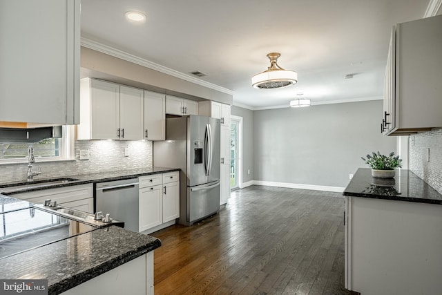 2107 Carol Ln, East Norriton, PA 19401 - kitchen featuring stainless steel appliances, plenty of natural light, dark stone counters, ornamental molding, and recessed lighting