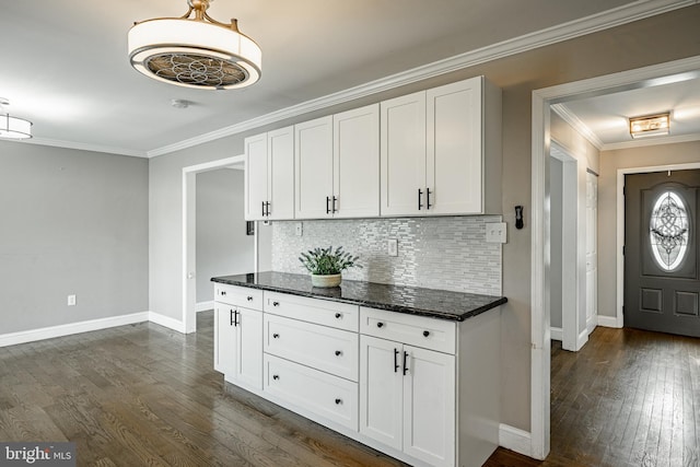 2107 Carol Ln, East Norriton, PA 19401 - kitchen with dark wood-style floors, tasteful backsplash, white cabinets, ornamental molding, and dark stone countertops