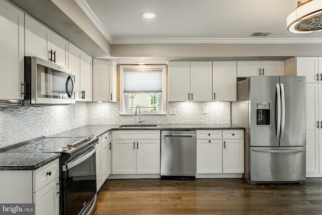 2107 Carol Ln, East Norriton, PA 19401 - kitchen featuring stainless steel appliances, crown molding, dark stone countertops, white cabinetry, and dark wood-style floors