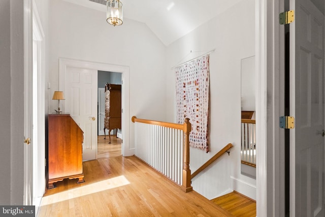 304 Summers Dr, Alexandria, VA 22301 - hallway with an upstairs landing, vaulted ceiling, and wood finished floors
