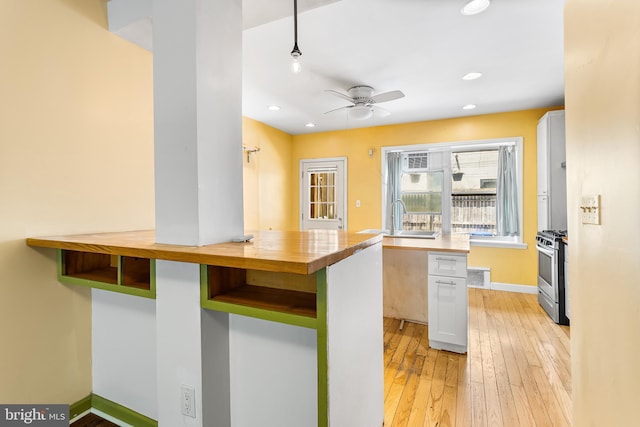 1148 S 12th St, Philadelphia, PA 19147 - kitchen with stainless steel range with gas cooktop, light wood-style floors, a ceiling fan, butcher block countertops, and recessed lighting
