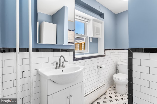 1148 S 12th St, Philadelphia, PA 19147 - bathroom with a baseboard heating unit, a wainscoted wall, vanity, and tile walls