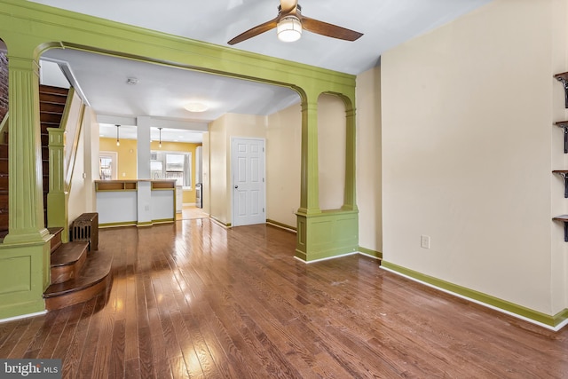 1148 S 12th St, Philadelphia, PA 19147 - unfurnished living room with ornate columns, a ceiling fan, and hardwood / wood-style flooring