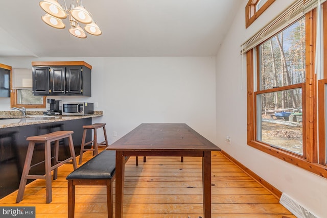 1702 Willow Brook Rd, Bumpass, VA 23024 - dining space featuring light wood-style flooring and a chandelier