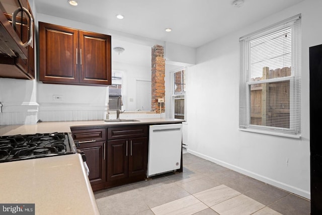 539 Fernon St, Philadelphia, PA 19148 - kitchen with white dishwasher, light countertops, light tile patterned floors, recessed lighting, and dark brown cabinets