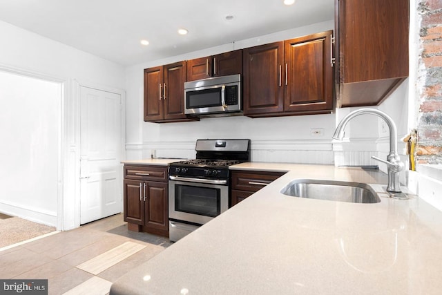 539 Fernon St, Philadelphia, PA 19148 - kitchen with stainless steel appliances, recessed lighting, light tile patterned floors, and dark brown cabinetry